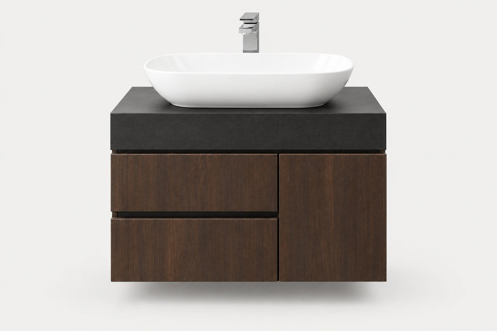 A modern floating bathroom vanity with a dark wood cabinet, a matte black top, and a white oval vessel sink with a chrome faucet, shown against a light gray background.