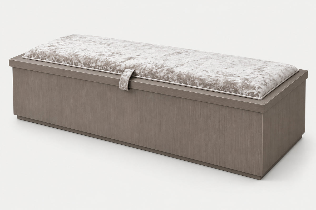 A rectangular storage bench with a textured taupe-brown wooden frame and a plush, crushed light gray cushion on top, shown on a clean white background.
