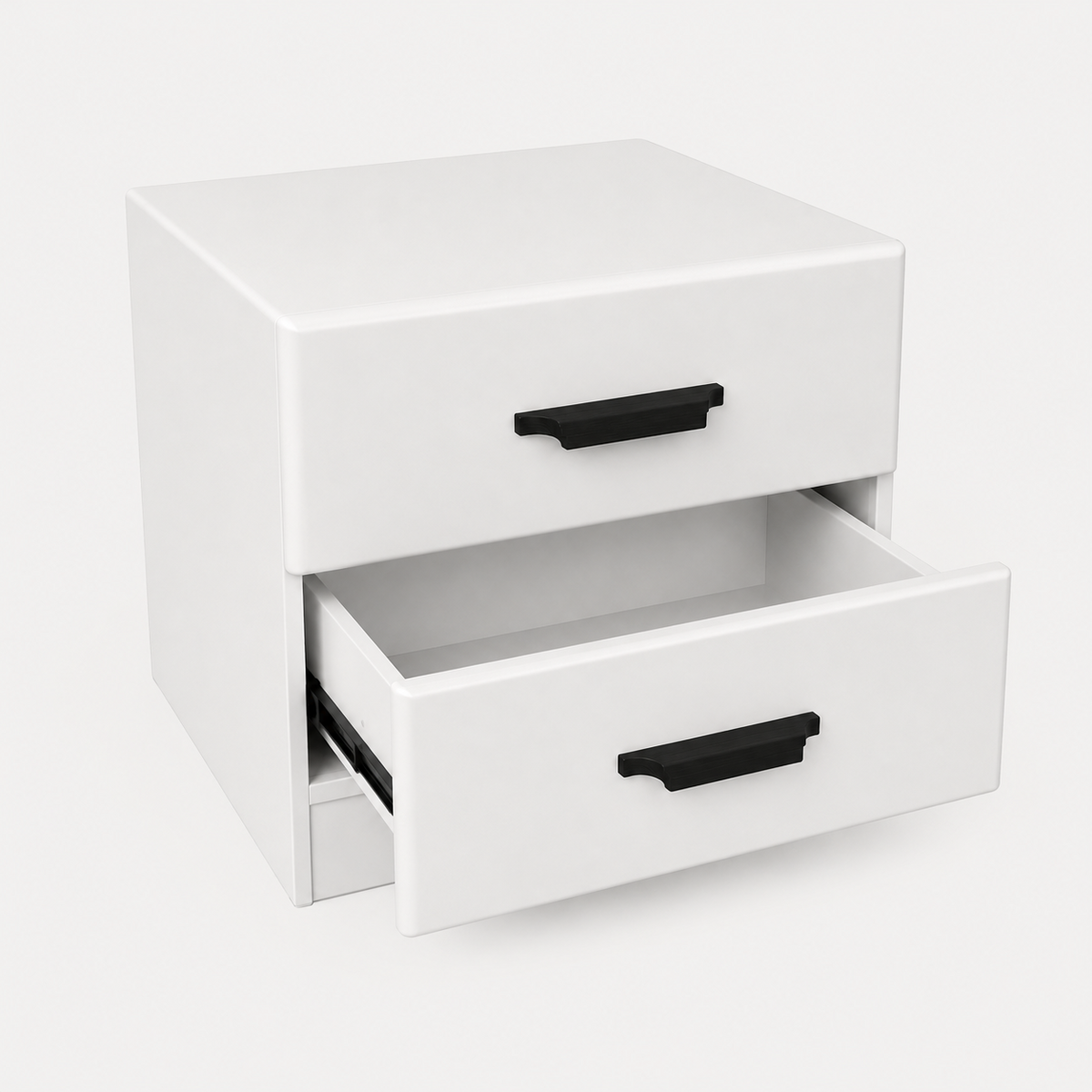 A white two-drawer nightstand or storage cabinet with black drawer pulls, shown on a clean light gray studio background. The lower drawer is slightly open, revealing the interior.
