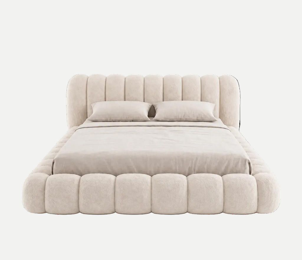 A modern platform bed with a high, vertically channel-tufted headboard and a matching padded footboard, upholstered in a textured light beige fabric. The bed is dressed in matching beige bedding, including two pillows, and is photographed against a seamless white background.