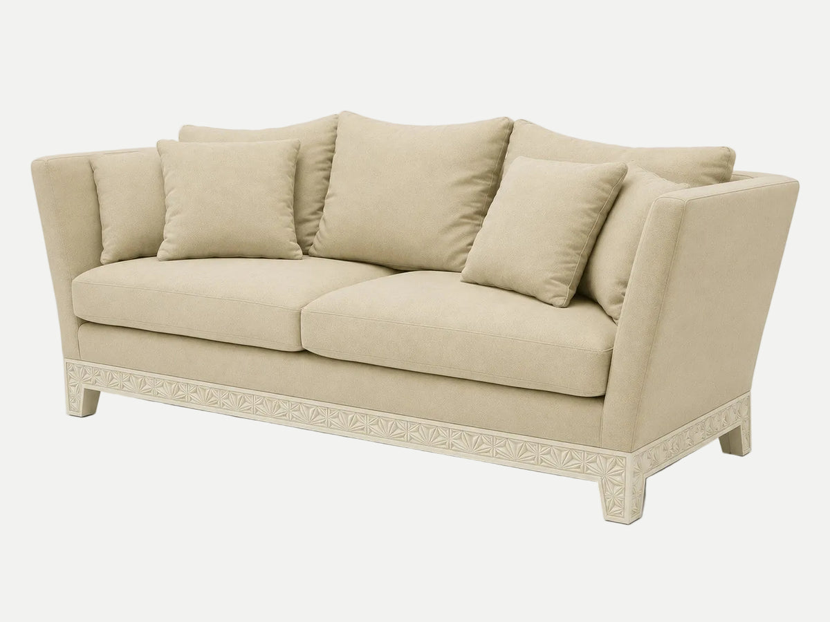 A beige upholstered Italian couch with matching back and seat cushions, shown at a three-quarter angle on a light gray studio background.