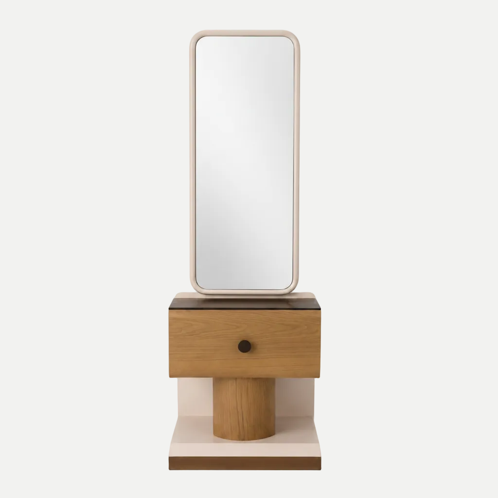 A modern wooden vanity table with a single drawer and cylindrical pedestal base, supporting a tall rectangular mirror with a light wood frame, shown on a white background.