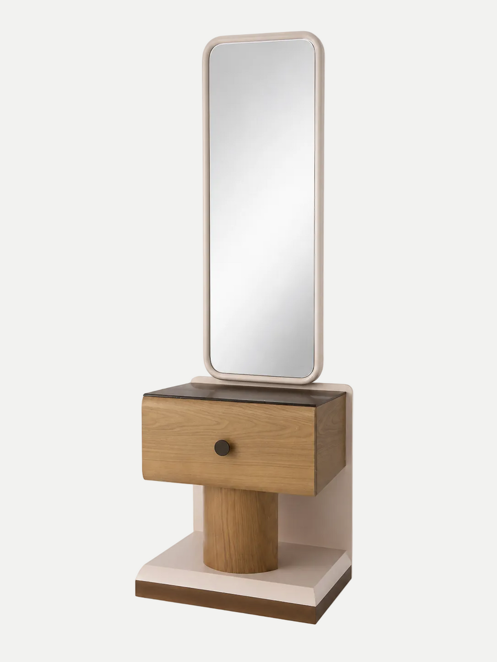 A modern vanity table with an integrated rectangular mirror, featuring a light oak wood drawer with a single dark metal knob, a cylindrical wood pedestal, and a cream-colored base, set against a plain light gray background.