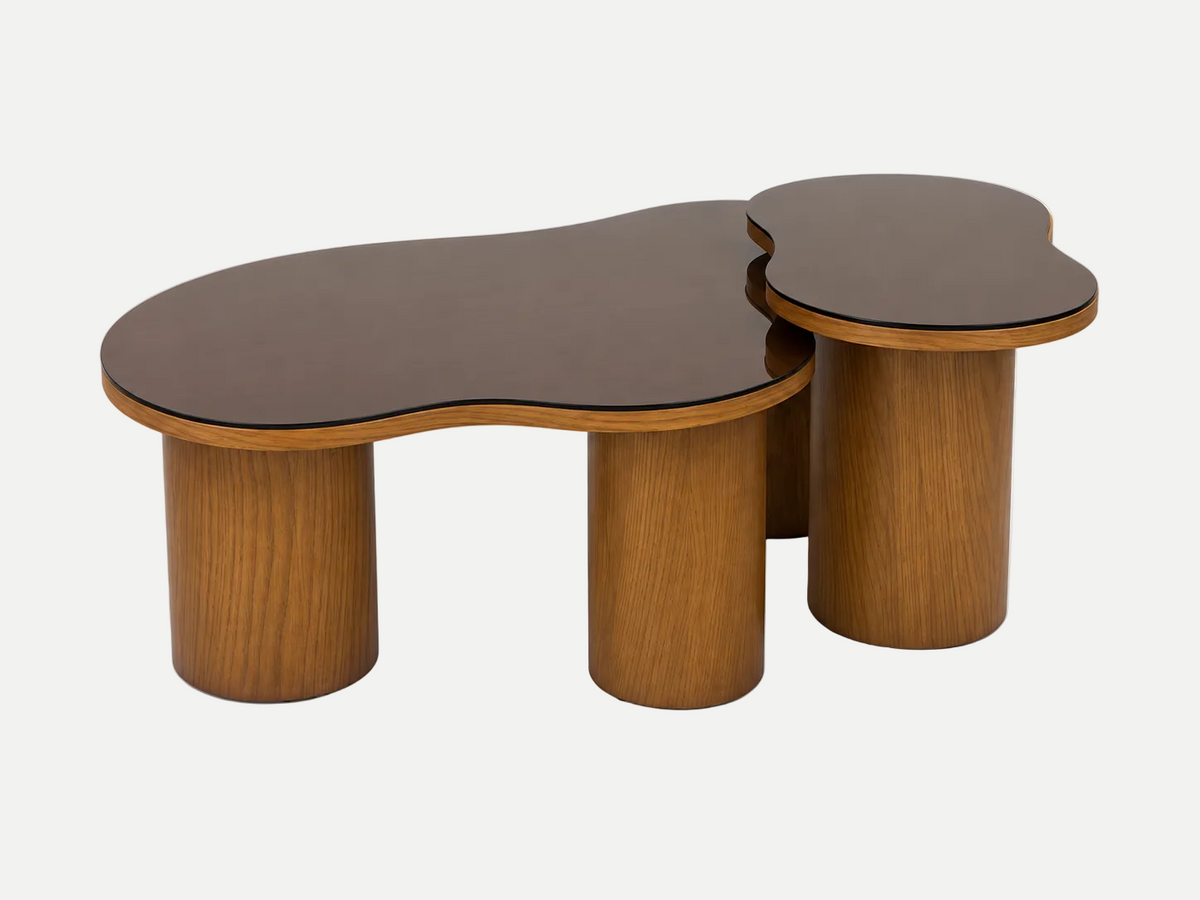 An organic-shaped wooden coffee table with a dark brown top and cylindrical wood legs, shown alongside a matching smaller side table on a clean white background.