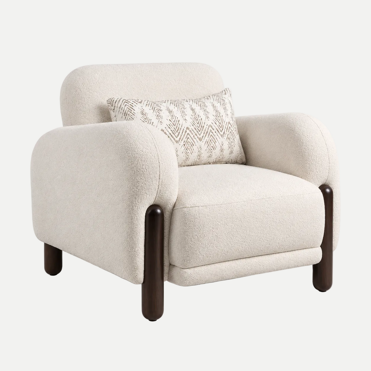 A modern upholstered accent chair in a textured cream bouclé fabric, featuring dark brown wooden legs and a matching cream patterned accent pillow, shown against a plain light gray background.