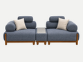 A modern modular sofa set with two blue-gray upholstered seat cushions, round backrests, light beige throw pillows, and a matching central ottoman with a gray top, all supported by a light wood frame, shown on a white background.