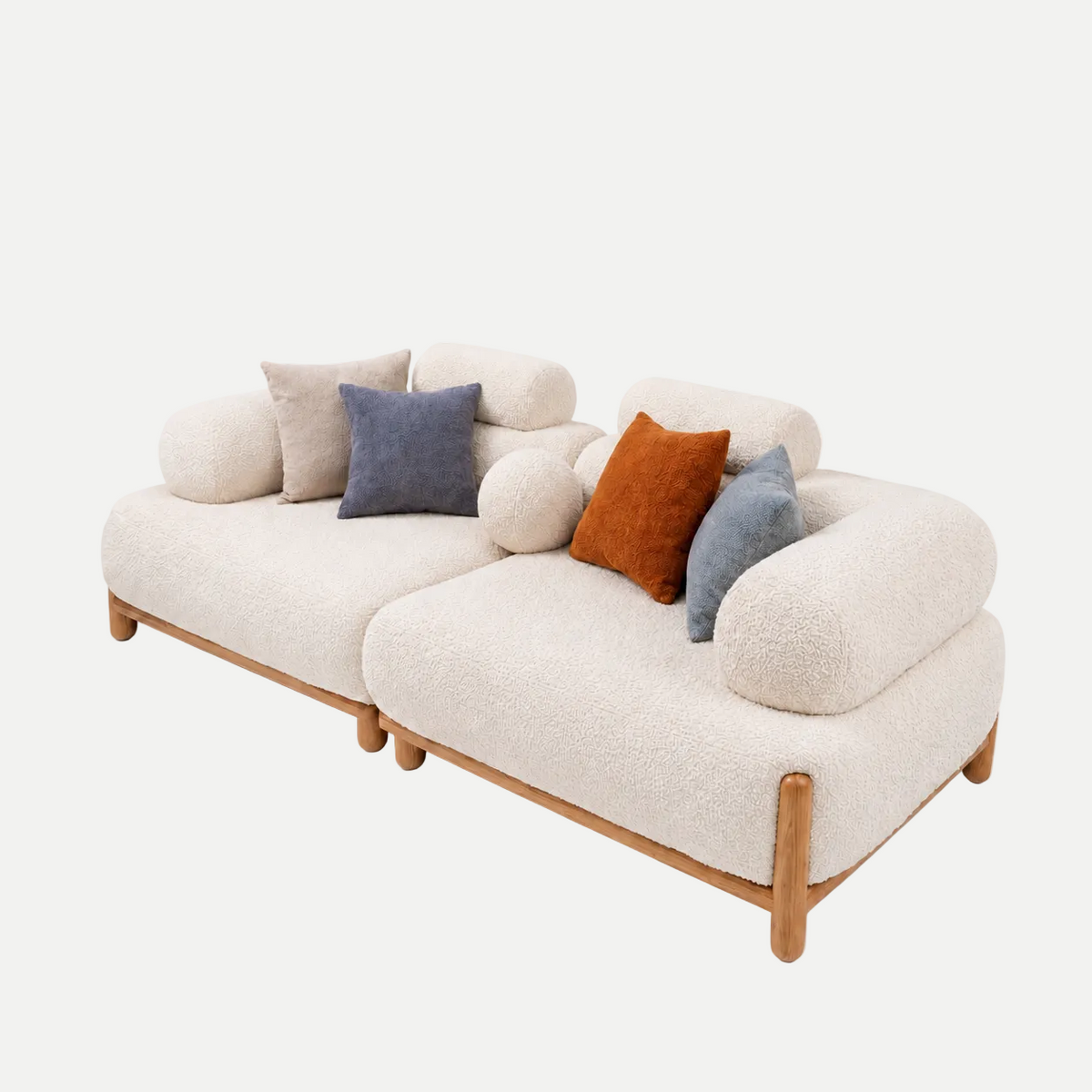 A modern two-seater sofa upholstered in cream bouclé fabric with a natural wood frame, styled with five decorative throw pillows in beige, blue, orange, and gray, set against a plain white background.