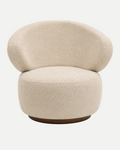 A modern round lounge chair upholstered in a textured cream bouclé fabric, featuring a low rounded backrest and a dark brown wooden base, shown against a plain white background.
