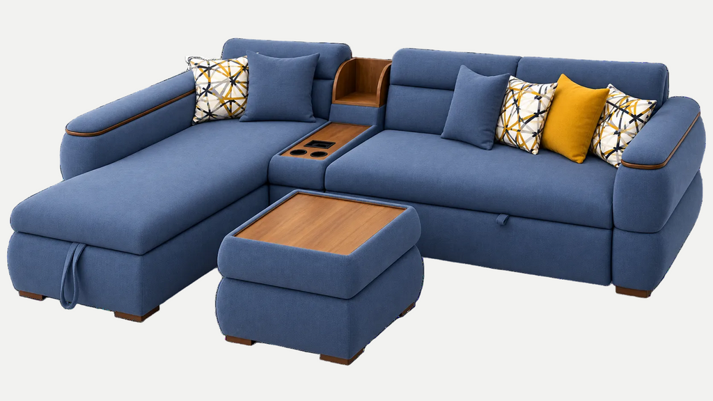 A blue sectional sofa with a chaise lounge, center console, and matching ottoman, styled with patterned and mustard yellow accent pillows on a plain white background.