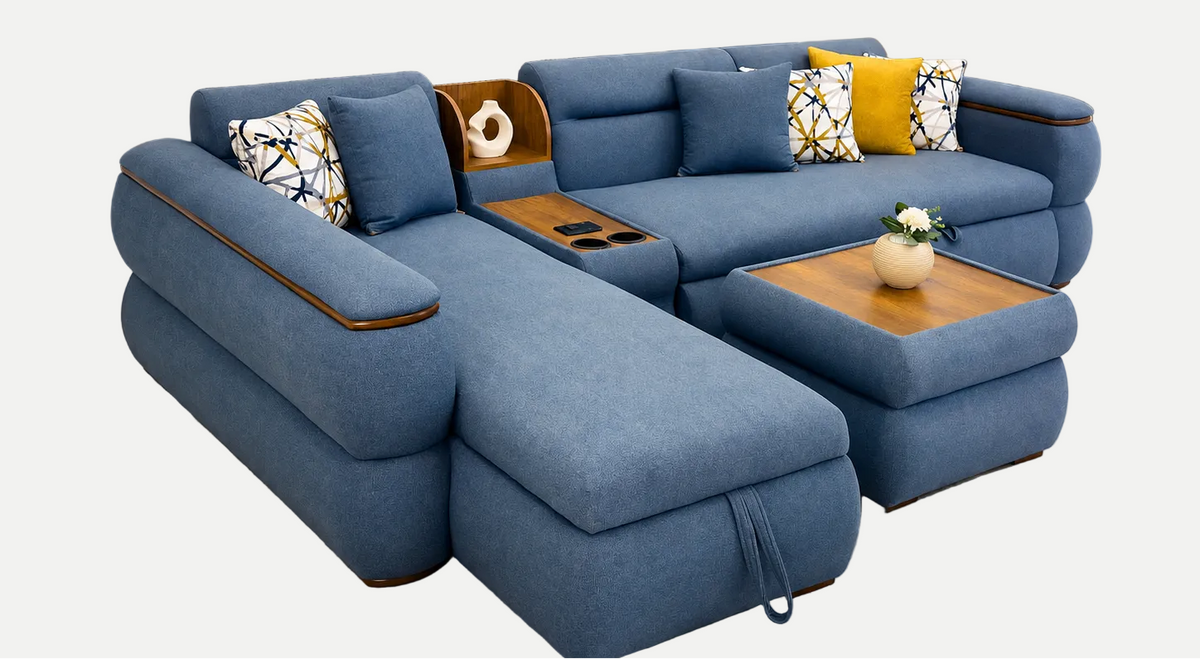 A modern blue fabric sectional sofa with a chaise lounge, wooden arm accents, and multiple decorative throw pillows, shown on a plain light gray background.