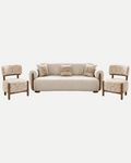 A modern three-piece sofa set featuring a cream upholstered sofa with wooden legs, flanked by two matching armchairs with patterned beige upholstery and wooden frames, set against a solid white background.