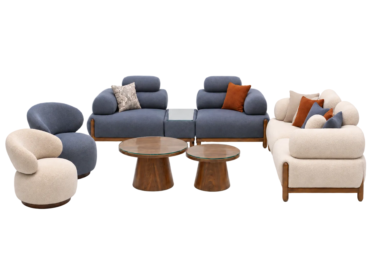 A mid-century modern furniture set featuring a blue modular sofa, a cream curved armchair, a matching cream sofa, two wooden coffee tables, and accent pillows, displayed on a light gray background.