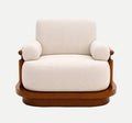A modern armchair with cream-colored fabric upholstery and a polished brown wooden frame, set against a plain white background.