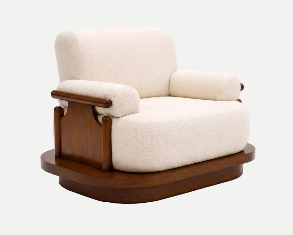 A modern armchair with cream-colored textured fabric upholstery and a dark brown wooden base and armrests, shown on a light gray background.