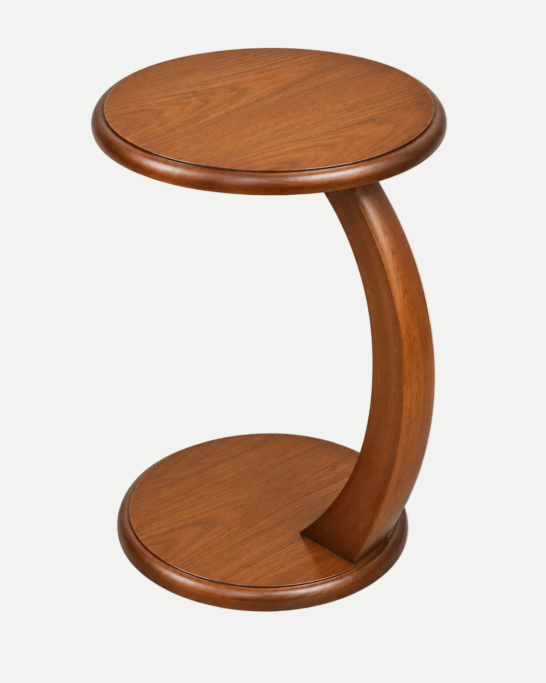 A mid-century modern wooden side table with a curved C-shaped pedestal base, featuring a round top and a matching round footrest, shown on a light gray background.
