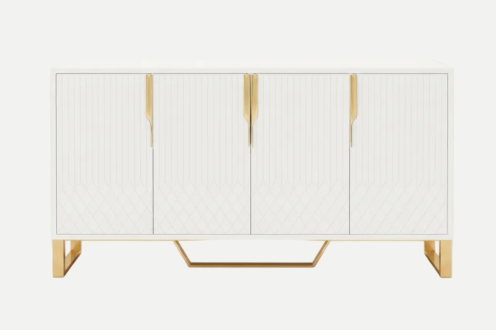 A modern white sideboard cabinet with four doors, featuring vertical ribbed detailing, geometric diamond patterns on the lower doors, and polished gold handles and legs, set against a clean light-grey background.
