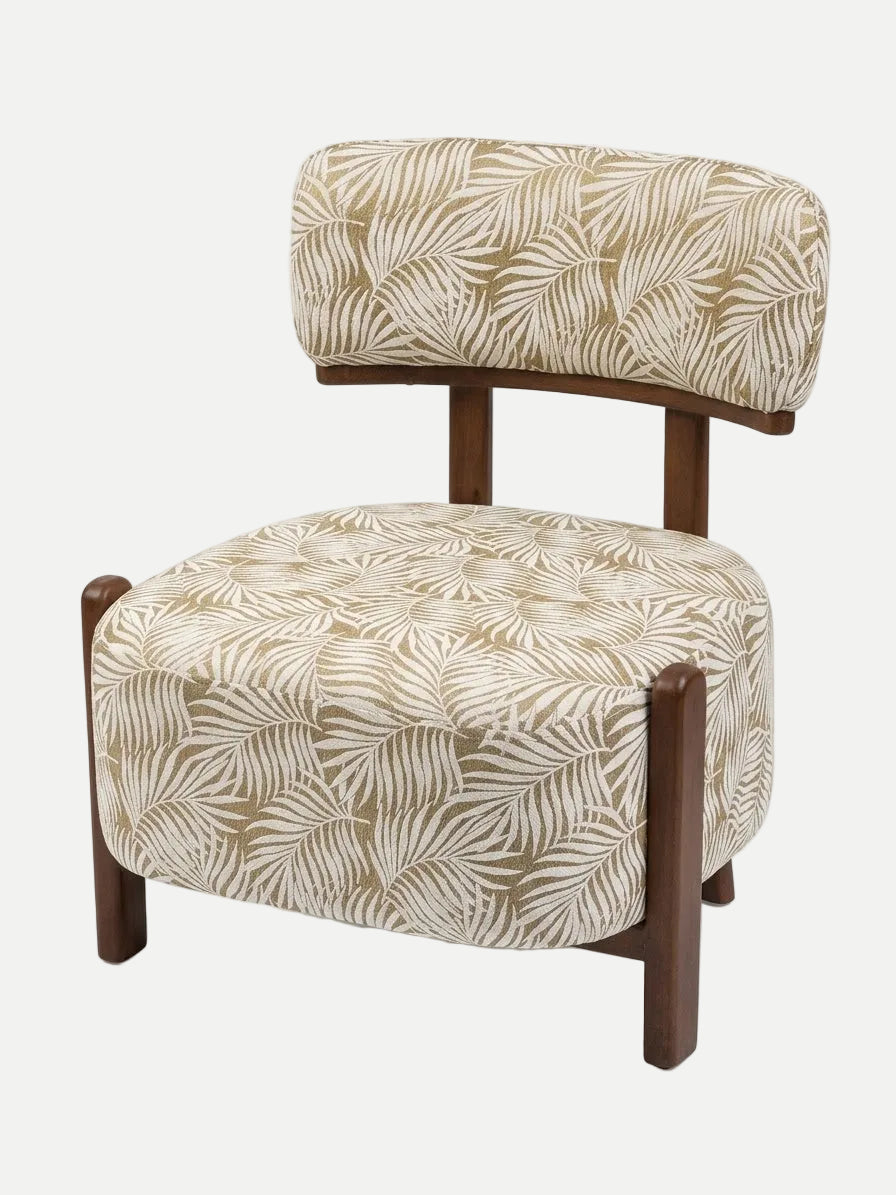 A modern accent chair with a curved backrest and square seat, upholstered in a beige and white palm leaf patterned fabric, supported by dark brown wooden legs and armrests, shown on a white background. Eleraky Furniture
