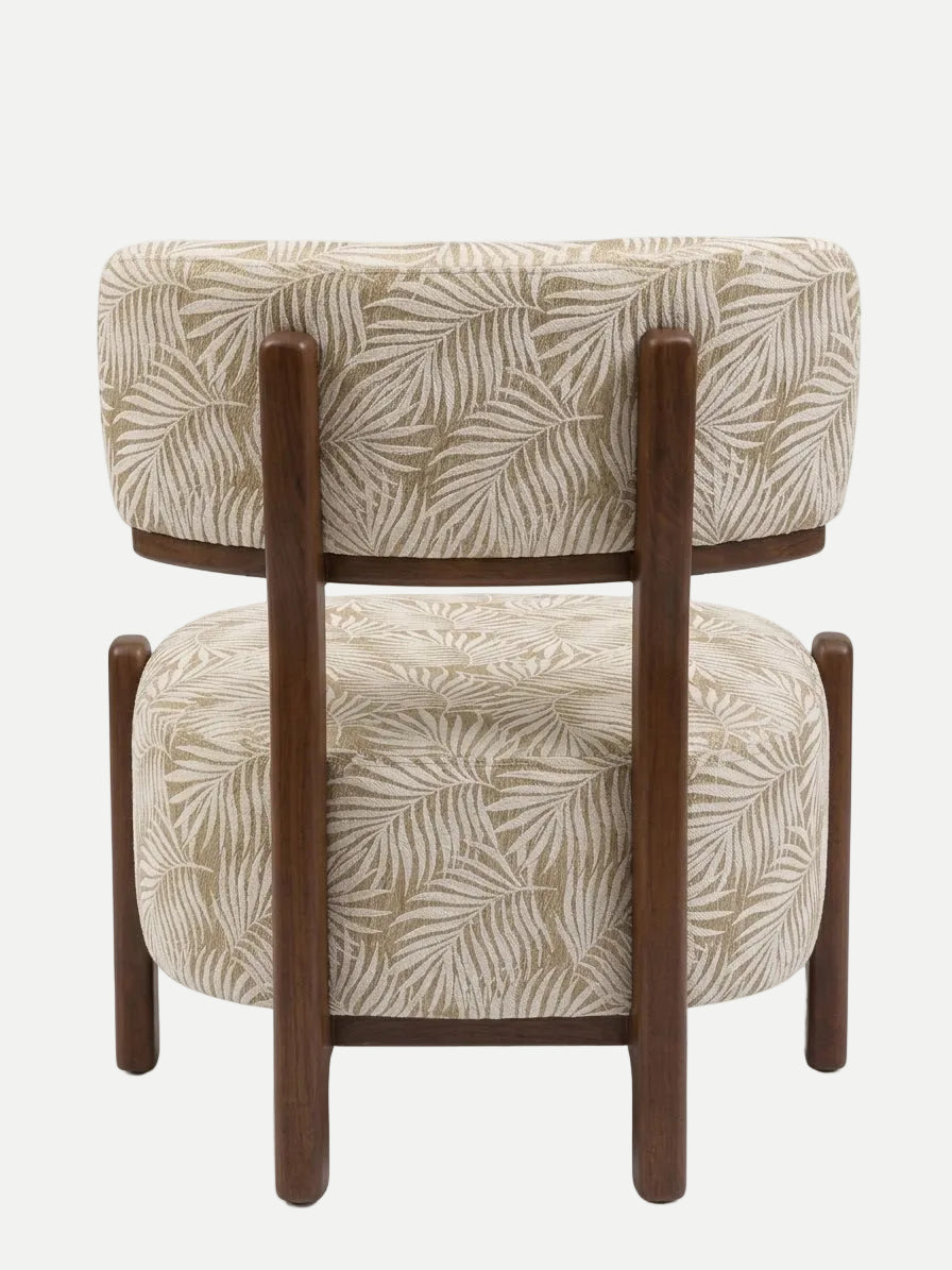 A modern accent chair featuring a double seat design with cushioned upholstered back and seat panels in a beige and brown palm leaf pattern, supported by a dark brown wooden frame with straight legs.