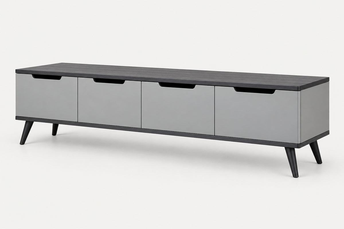 A modern long media console with four gray drawer fronts, a dark charcoal top, and black legs, shown on a light gray background.