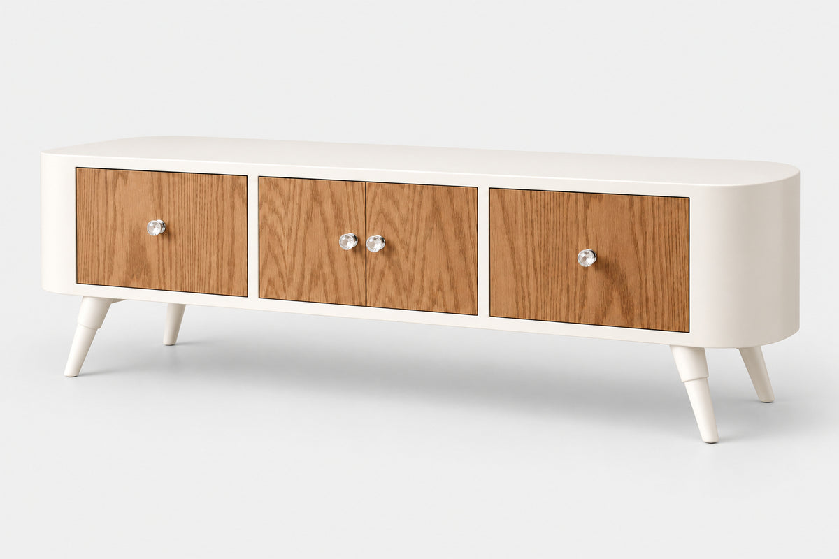 A mid-century modern TV stand or console cabinet with a white frame, three wood-grain doors, and tapered white legs, shown on a light gray studio background.
